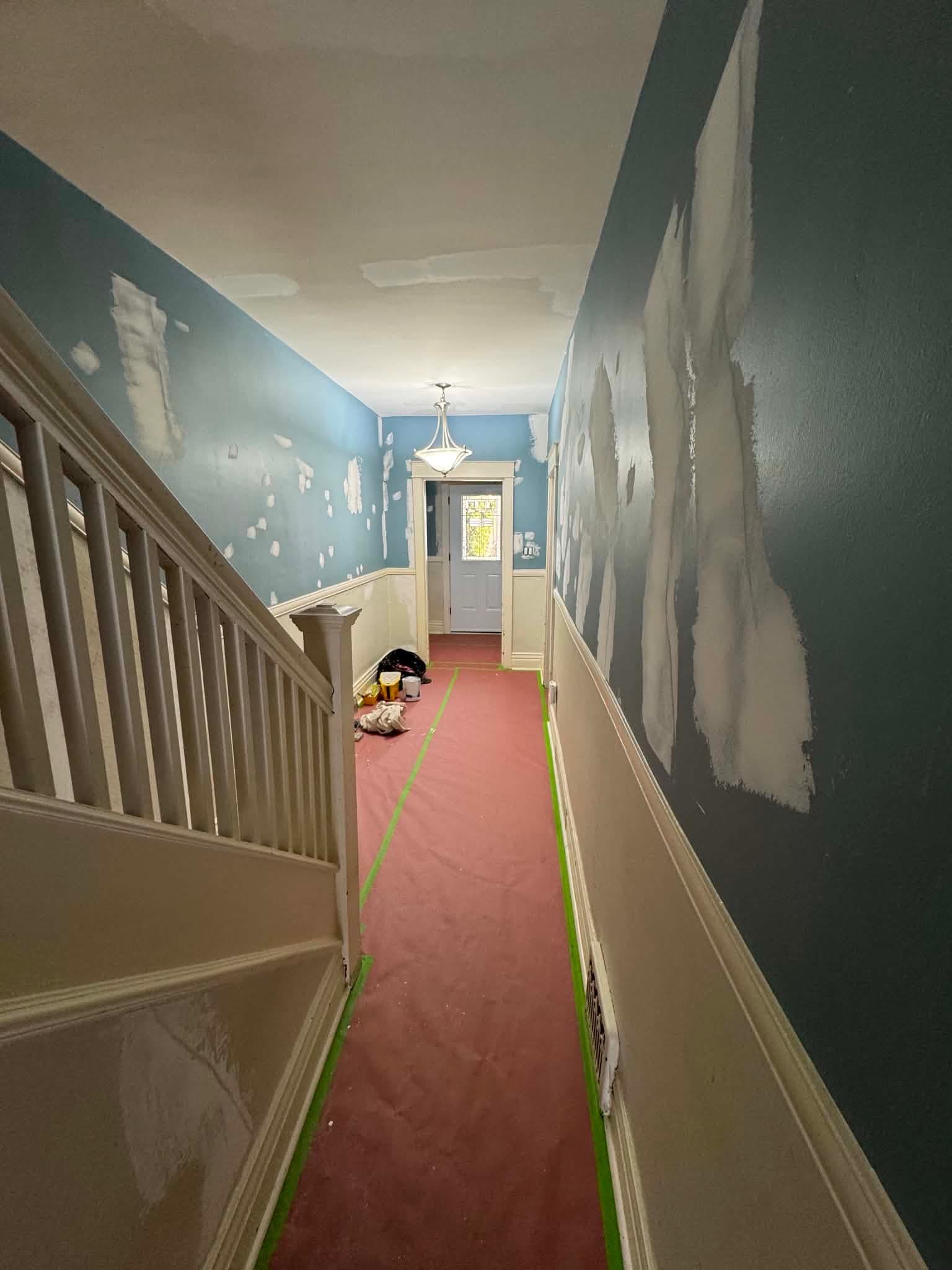 A hallway in an older Toronto home patched and prepped, with repaired plaster ready for paint